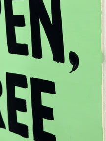 Close-up of bold black message lettering on the pale green surface of STAY OPEN, STAY FREE, TAROART by TAROUT 00032