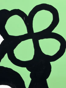 Close-up of the black outlined flower held by LUNNY in STAY OPEN, STAY FREE, TAROART by TAROUT 00032