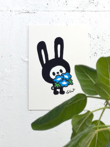 WHAT DO YOU COLLECT?, TAROART by TAROUT 00055, displayed on a white wall beside a green plant