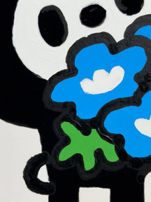Close-up of blue flowers and LUNNY's black painted face in WHAT DO YOU COLLECT?, TAROART by TAROUT 00055