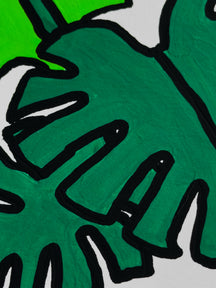 Close-up of green monstera leaves and black painted lines in Little Monstera