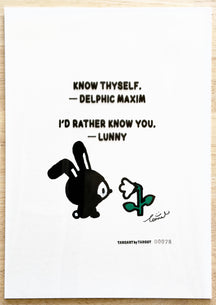 TAROART by TAROUT 00078, I'D RATHER KNOW YOU.: LUNNY facing a white flower with a green stem and leaves. Actual artwork photographed with its printed transparent sheet in place: “KNOW THYSELF.” — Delphic maxim; LUNNY replies “I'D RATHER KNOW YOU.”.